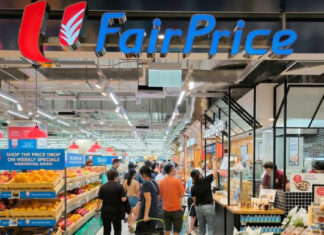 Shoppers crowd a FairPrice supermarket under the FairPrice sign