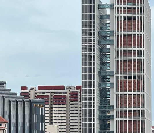 Man Poses as Police Officer and Collects Nearly S$200,000 From Scam Victims; Jailed and Caned Exterior of State Courts Towers in Singapore