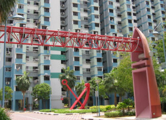 Red steel arch sculpture in front of HDB blocks at Marine Crescent, Singapore