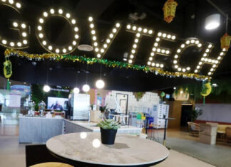 GovTech illuminated sign above a cafe area in the agency office