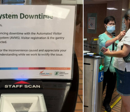 Signage about a visitor management system downtime and staff manually registering visitors at Singapore General Hospital