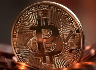 Gold bitcoin coin on a dark surface