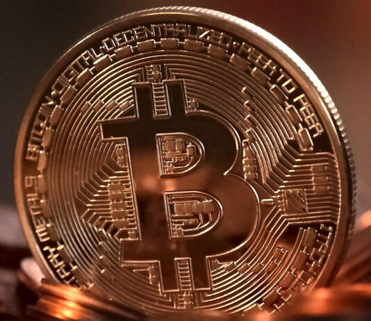 Man Allegedly Cheats Friend of At Least S$186,000 After Offering to Recover Scam Losses Gold bitcoin coin on a dark surface