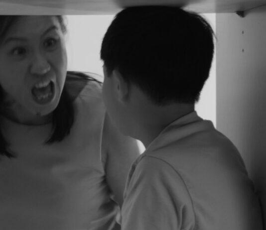 Black-and-white scene of an angry woman shouting at a child