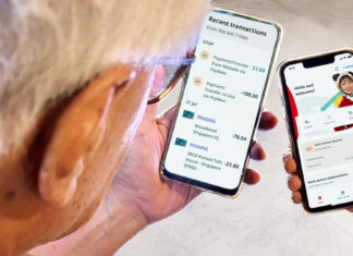 Two smartphones showing the OCBC banking app held in hands