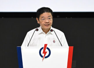PM Wong Criticises WP’s Housing & Foreign Manpower Positions, Warns Against Populism PM Lawrence Wong speaking at a PAP podium