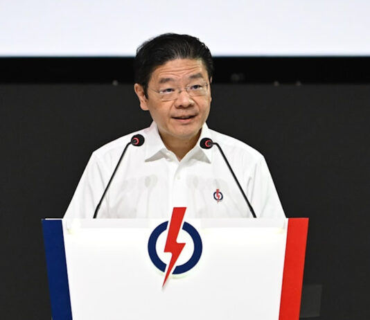 PM Wong Criticises WP’s Housing & Foreign Manpower Positions, Warns Against Populism PM Lawrence Wong speaking at a PAP podium