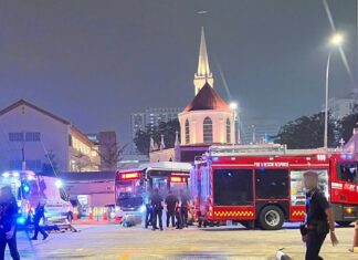 Woman, 30, Dies After Queen Street Bus Terminal Accident; Bus Driver, 32, Arrested SCDF and police vehicles and officers at Queen Street Bus Terminal on the night of 6 October 2026
