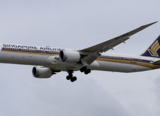 Singapore Airlines Boeing 787-10 in flight against a cloudy sky
