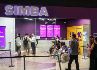 Customers queuing inside a SIMBA store with a purple SIMBA sign and 10 Gbps broadband posters