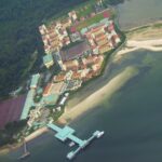 File aerial view of the Basic Military Training Centre camp on Pulau Tekong, with its jetty and the surrounding forest and sea, taken in 2008 (Photo: Tunafish1990 / Wikimedia Commons, CC BY-SA 3.0)