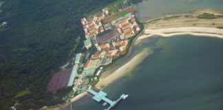File aerial view of the Basic Military Training Centre camp on Pulau Tekong, with its jetty and the surrounding forest and sea, taken in 2008 (Photo: Tunafish1990 / Wikimedia Commons, CC BY-SA 3.0)