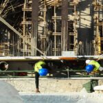 Construction and Transport Firms Urged to Hold Safety Time-Out After 7 Workplace Deaths Since September Two construction workers in blue hard hats and safety vests seen from above at a building site (stock photo: Pexels)
