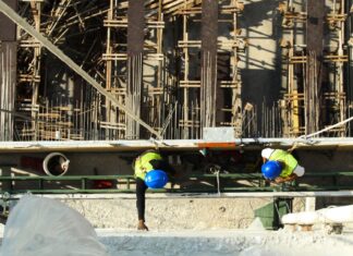 Construction and Transport Firms Urged to Hold Safety Time-Out After 7 Workplace Deaths Since September Two construction workers in blue hard hats and safety vests seen from above at a building site (stock photo: Pexels)